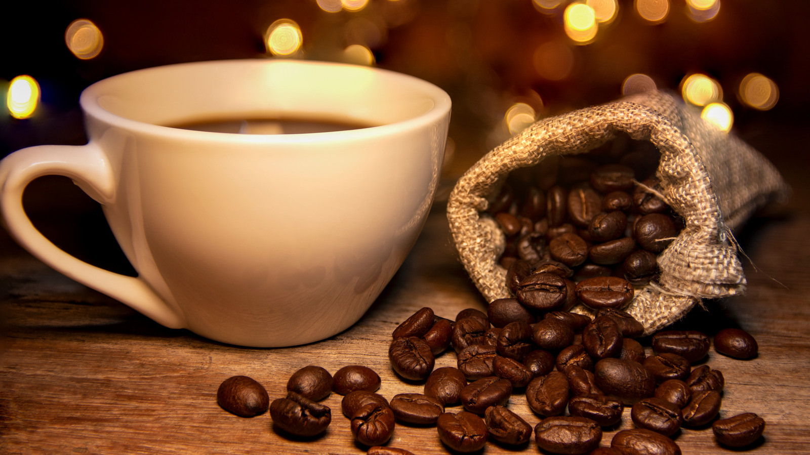 Roasted,Coffee,Beans,And,Bags,Placed,On,A,Wooden,Table,