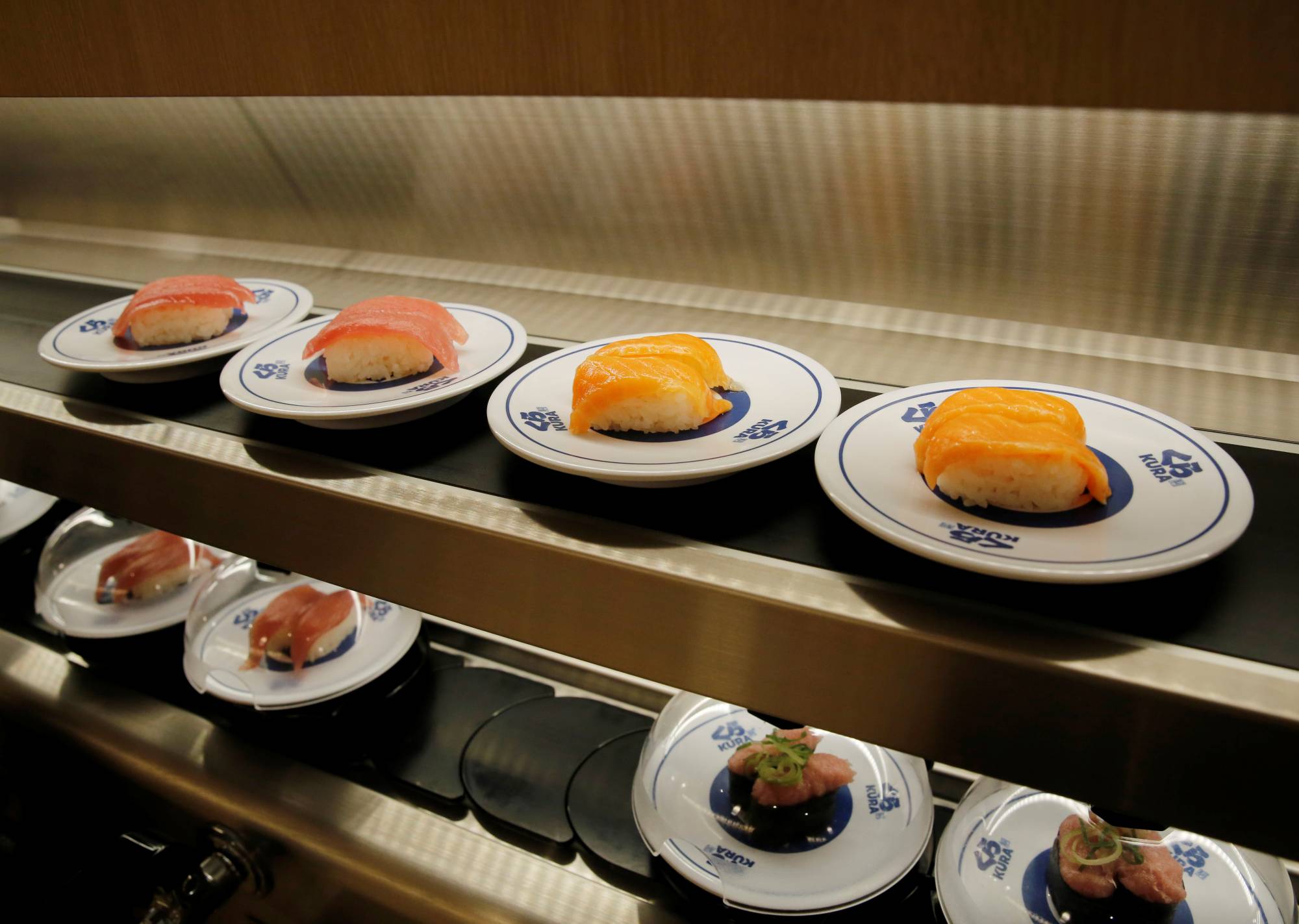 Sushi is seen on conveyor belt at Kura Sushi restaurant in Tokyo